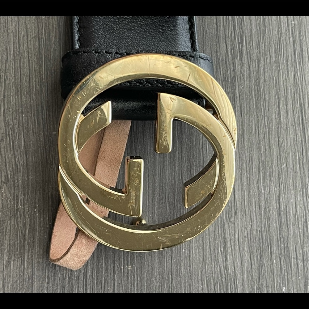 Gucci black belt with gold buckle.
